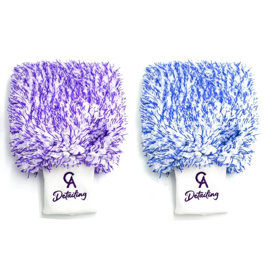 Two fluffy detailing mitts in purple and blue with embroidered logo on white cuffs.