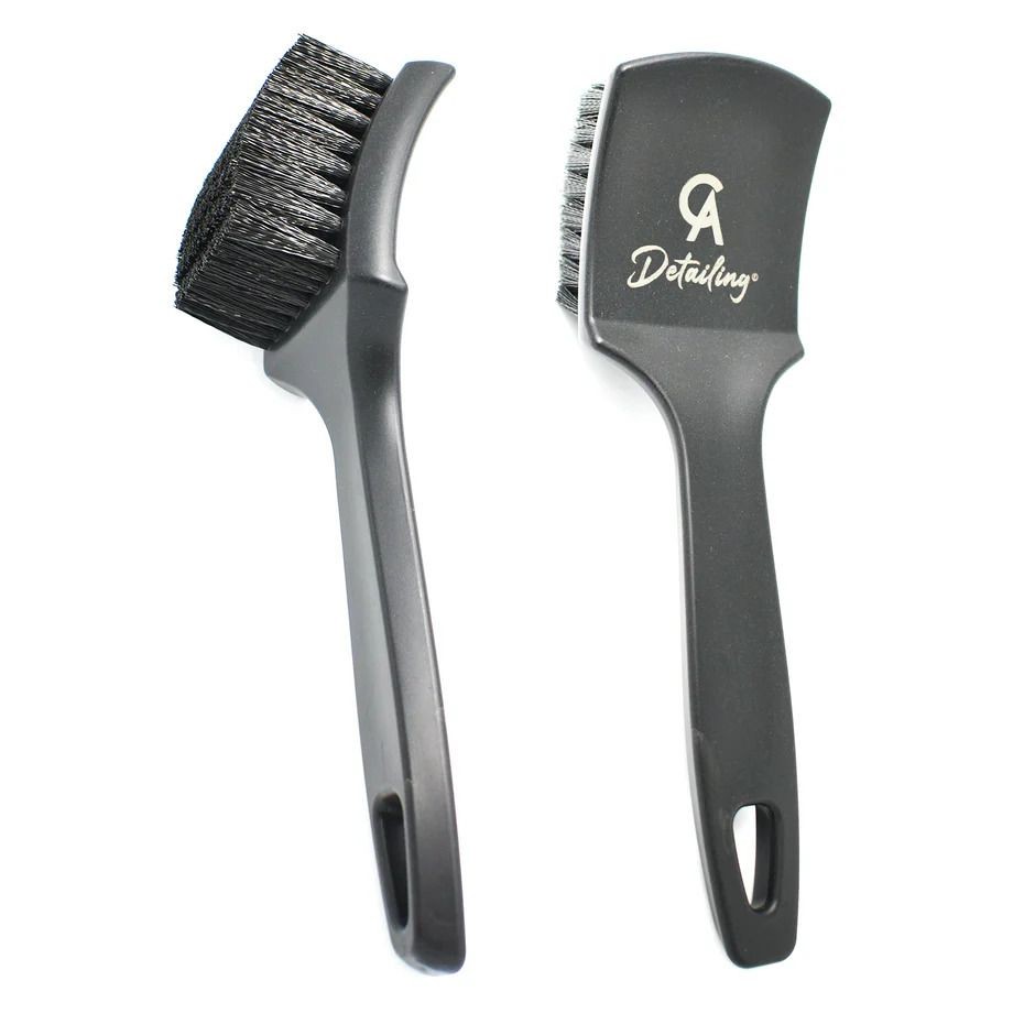 Two black detailing brushes with synthetic bristles and ergonomic handles on a white background.