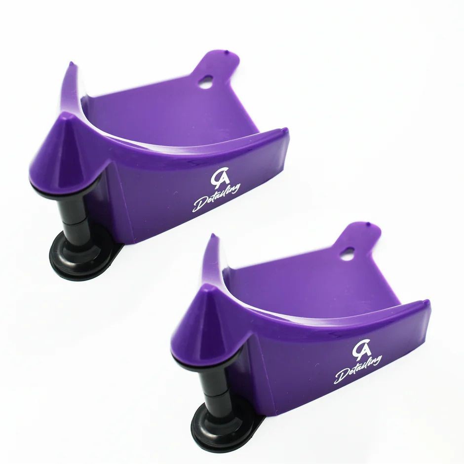 Two purple plastic wall mounts with suction cups, branded with 'Detailing' logo.