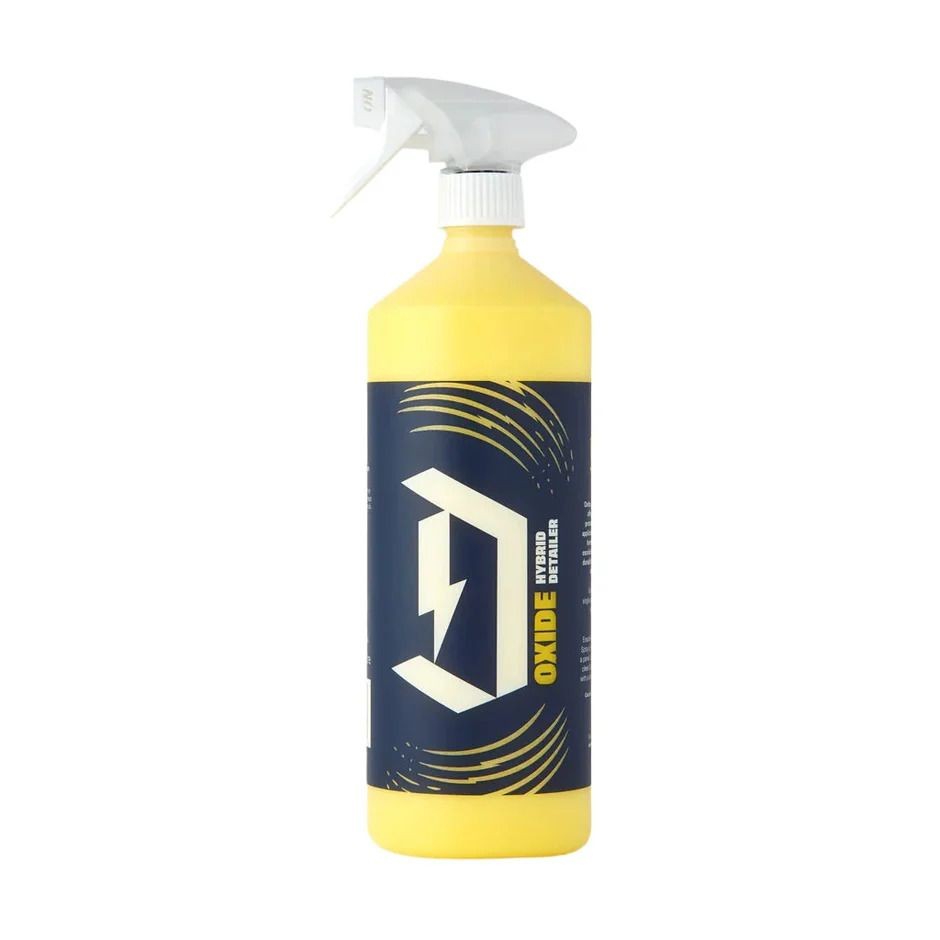 Yellow spray bottle of Oxide Hybrid Detailer with a dark blue label and white nozzle.