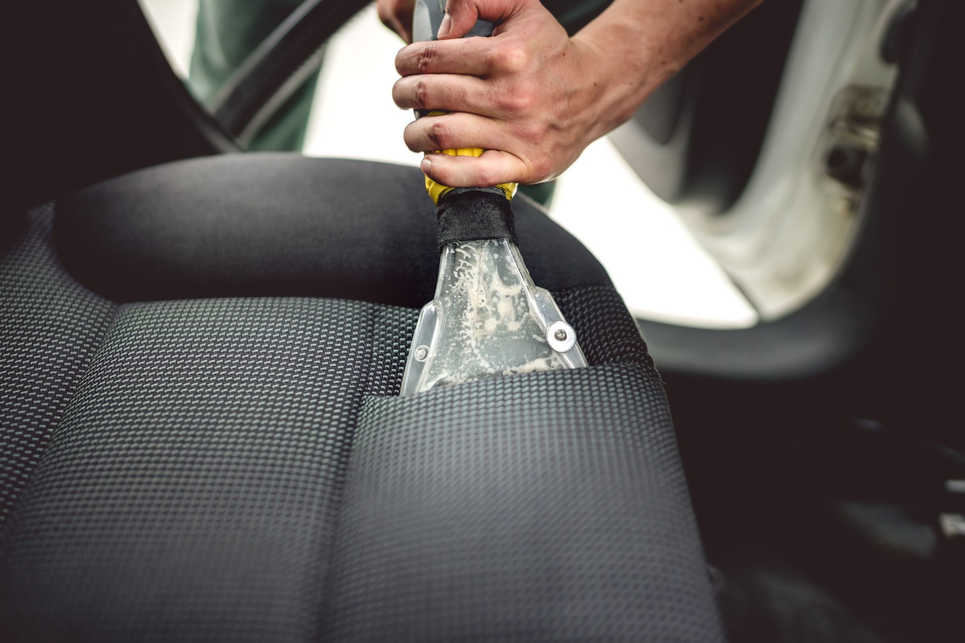 Detailing on interior of modern car. Details of upholstery vacuuming